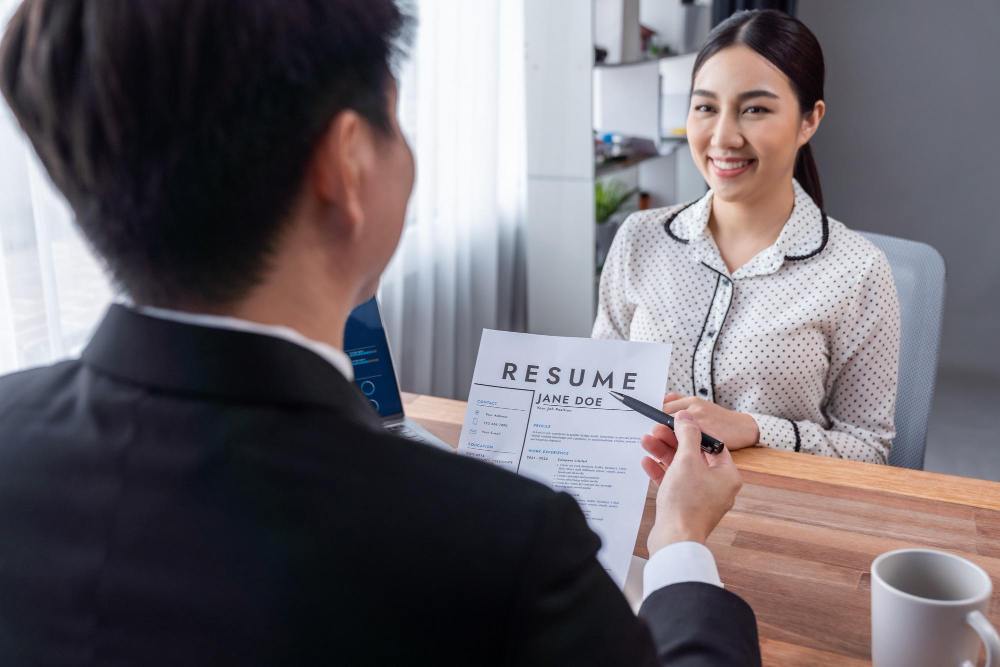 Employer in Malaysia conducting a direct hire interview with a qualified candidate, reviewing resume details during a professional recruitment process
